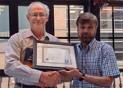 photo of Eugene Demidenko receiving 'Outstanding Book in Statistics' book award for 'Advanced Statistics with Applications in R' at the Joint Statistical Meetings in August 2022