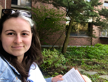 Lizzie Buchanan outdoors with book