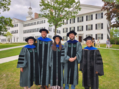 the four graduates and Professor Rosa Orellana in regalia